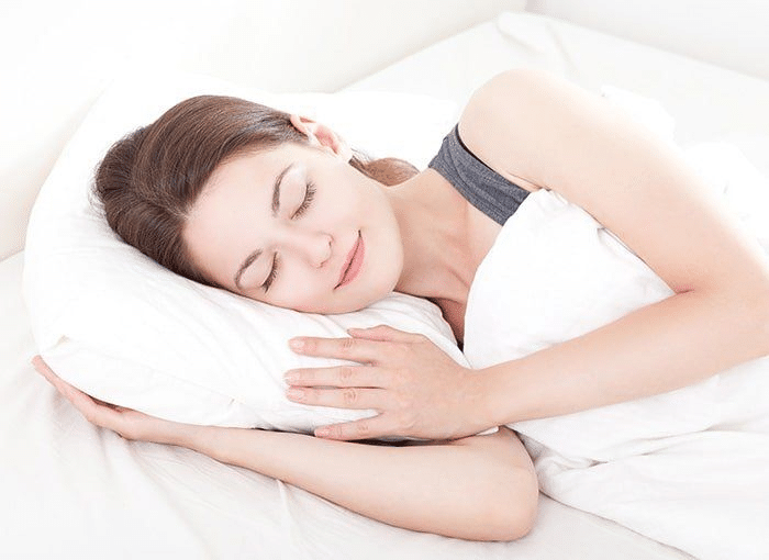 woman sleeping peacefully on her side in bed