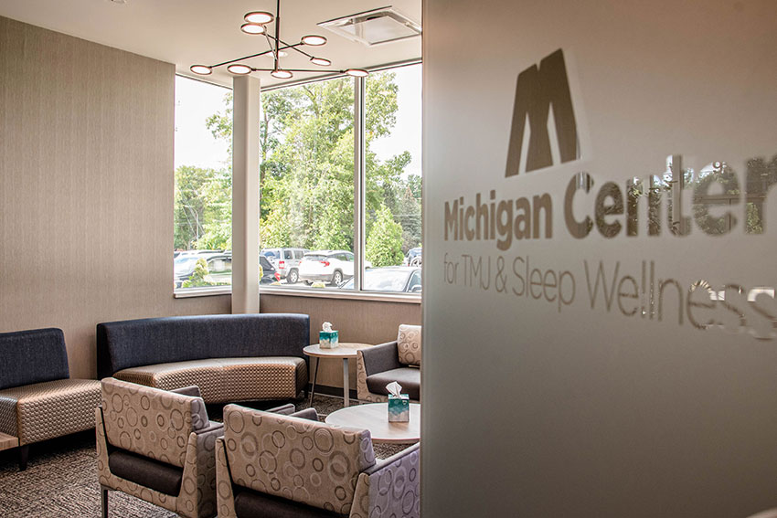 entry way of Michigan Center for TMJ & Sleep Wellness with logo on the glass wall