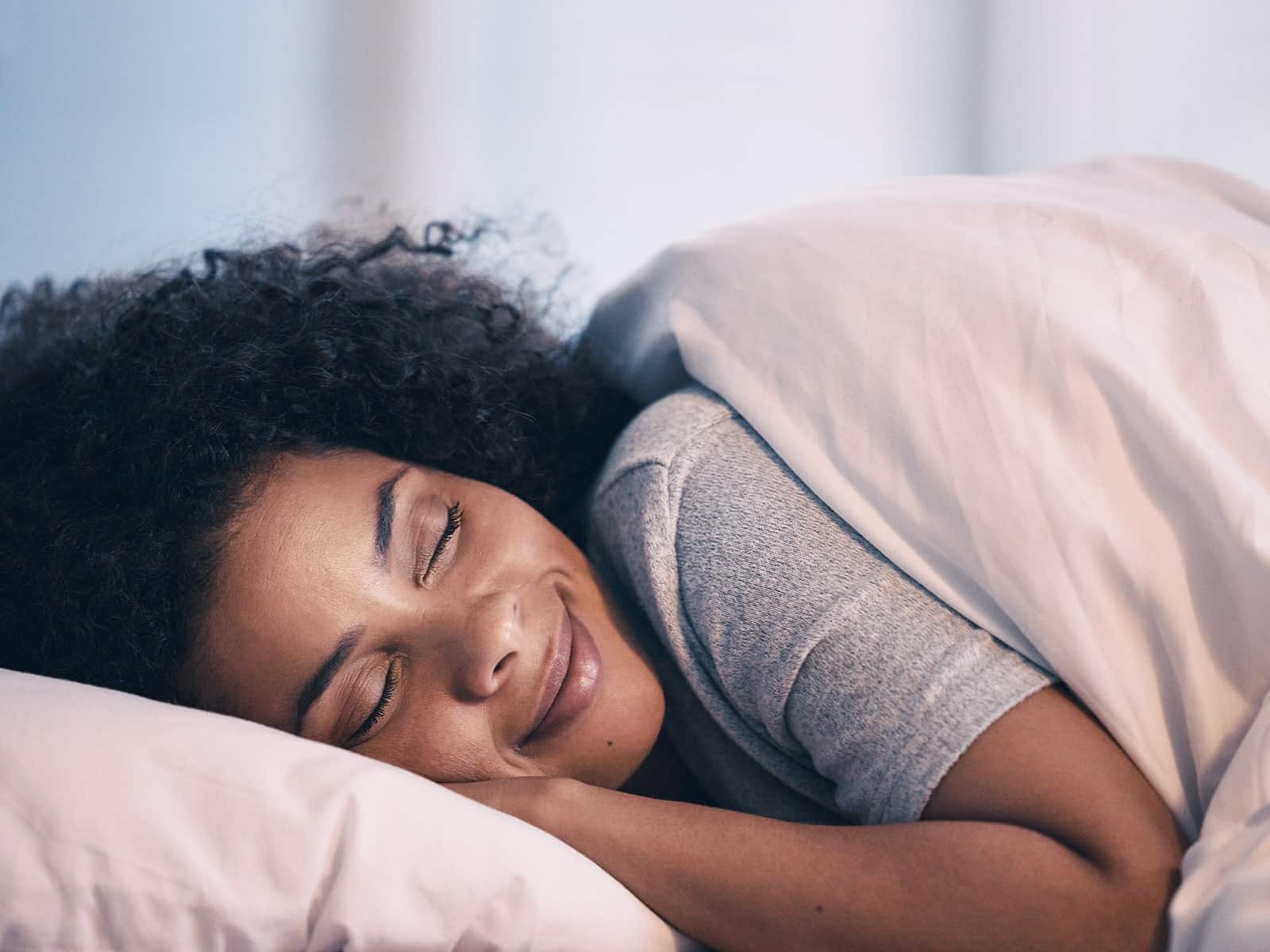 Woman smiling in her sleep