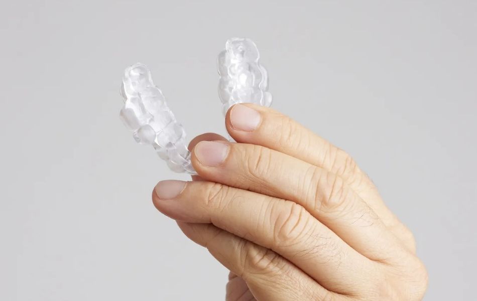 Holding Prosomnus Evo 1 Custom oral appliance designed to treat sleep apnea with a comfortable, discreet fit.