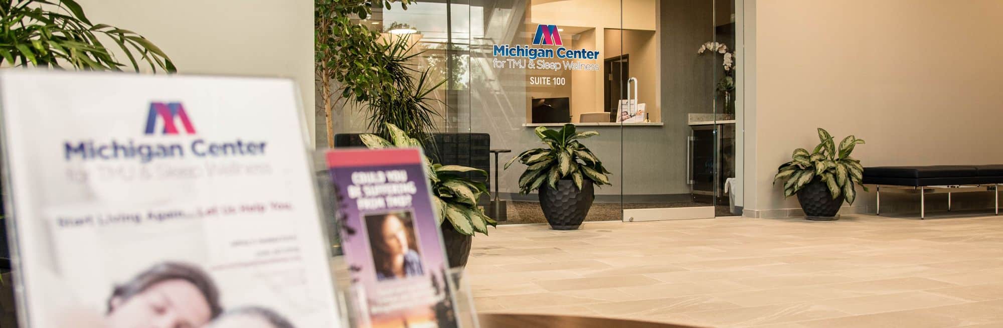 Home second opinions banner Michigan Center for TMJ & Sleep Wellness reception area with modern seating and welcoming office entrance.