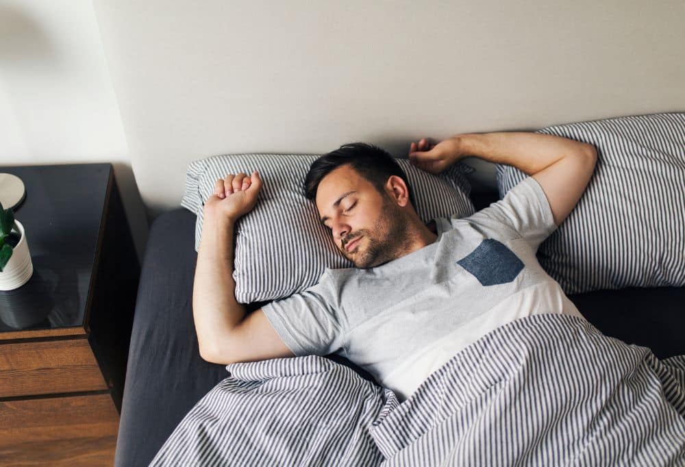 Home sleep studies service card Man sleeping peacefully in bed, illustrating restful sleep and improved sleep quality.