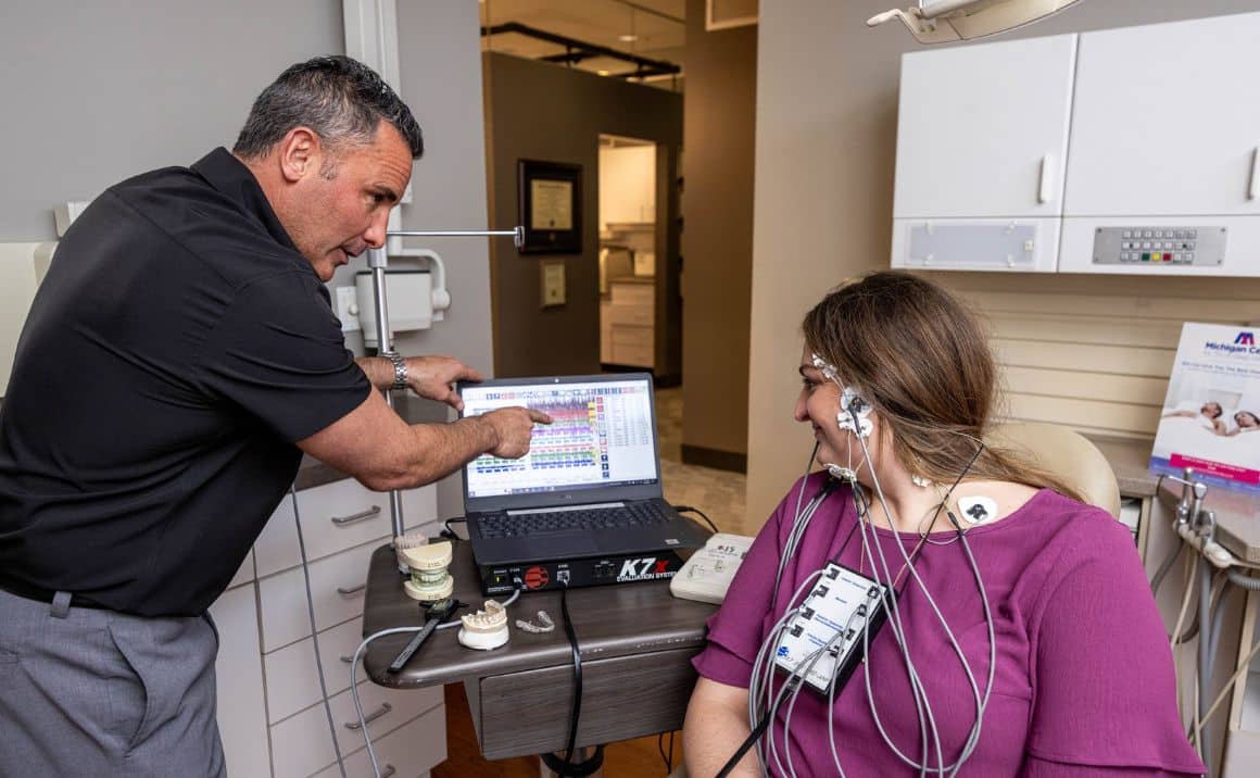 Patient Resources content image 1 2 Dr. Haddad reviewing computerized TMJ diagnostic results with a patient during a personalized treatment consultation.