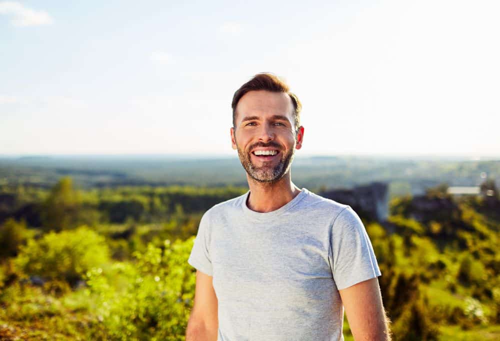 Service card image 2 Smiling man outdoors, representing improved well-being and renewed energy after treatment.
