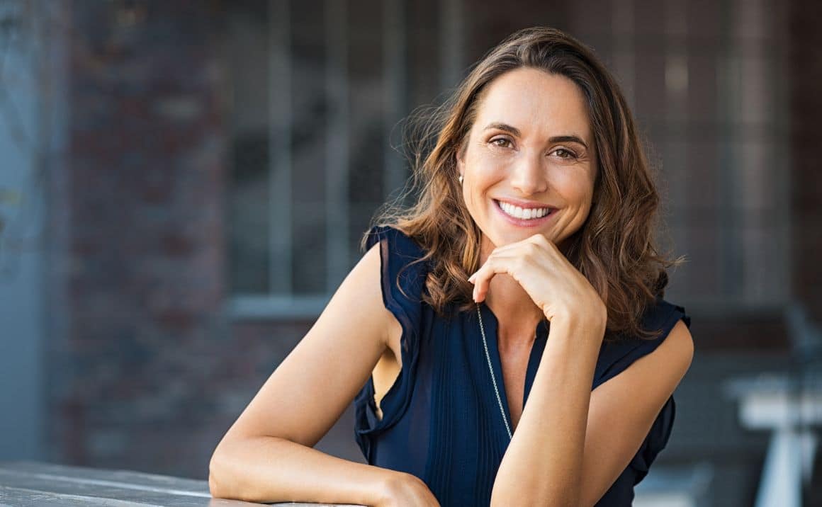 Service page content 10 Smiling woman leaning forward, conveying warmth, confidence, and improved quality of life.
